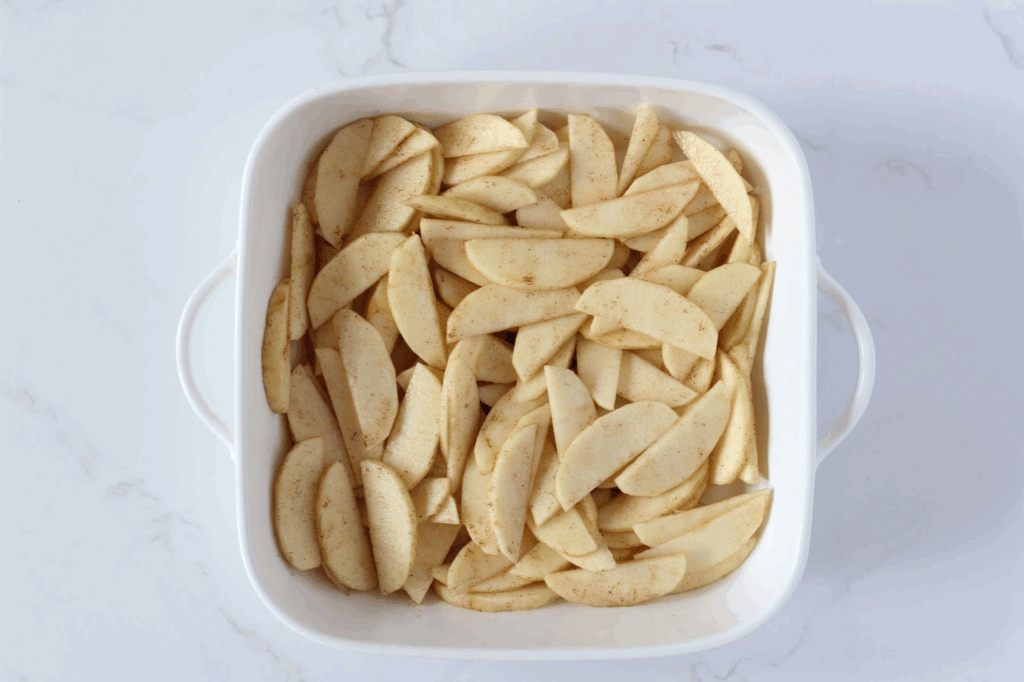 cinnamon apple slices in white baking dish