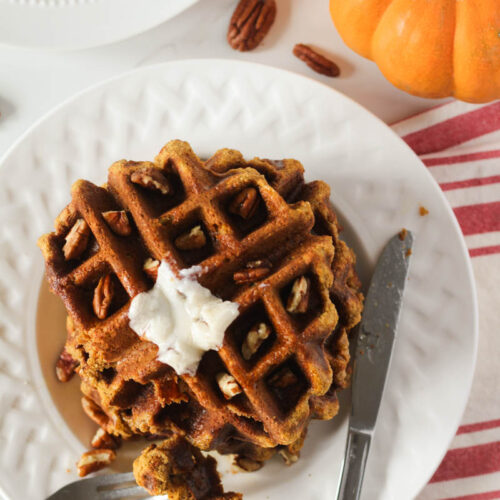 Gluten free pumpkin waffles on white plate