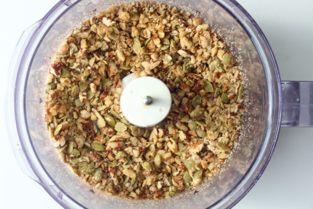 chopped walnuts, pecans, and pumpkin seeds in food processer