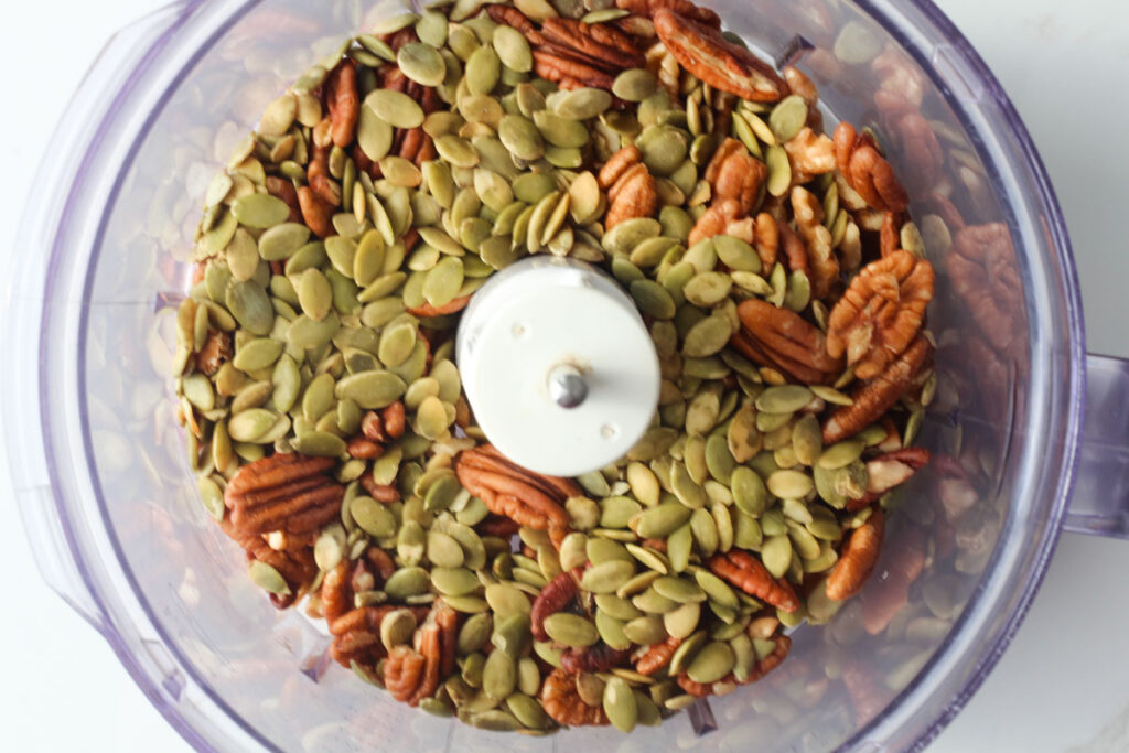 walnuts, pecans, and pumpkin seeds in food processer