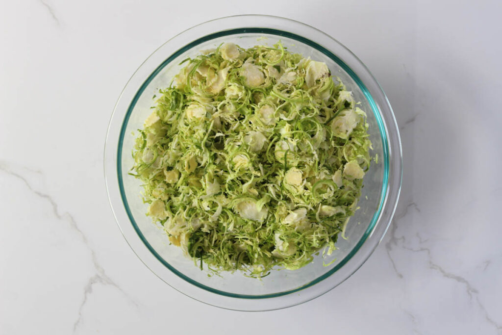 shredded Brussels sprouts in glass bowl