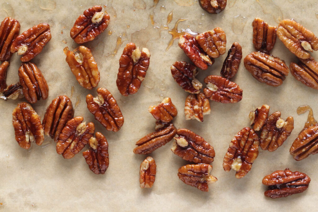 toasted maple pecans on parchment paper
