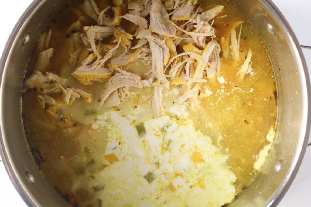 adding shredded chicken, coconut milk, and lemon juice to soup